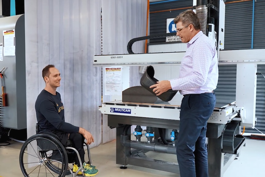 Tom O'Neill Thorne and Matt Crawford look at a seat while in a lab at the AIS.