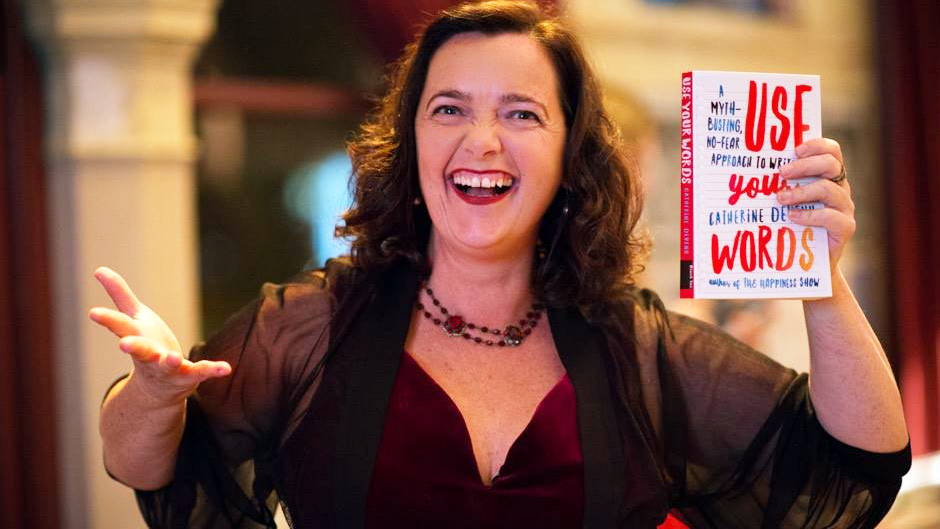 Writer and proud dyslexic Catherine Deveny holds up her ninth published book, Use Your Words.