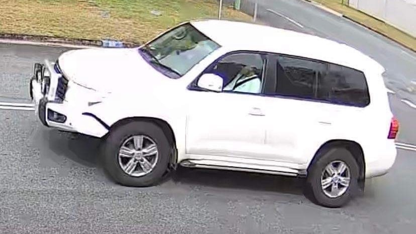 a CCTV still image of a white Landcruiser from the side angle