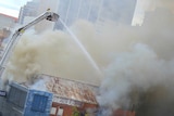 Firefighters battle a fire inside a building on Schrader Street in the Adelaide city centre.