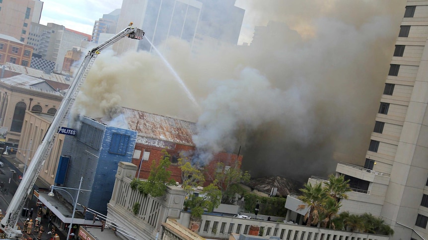 Firefighters battle a fire inside a building on Schrader Street in the Adelaide city centre.