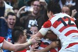 Japan celebrates winning try against Springboks