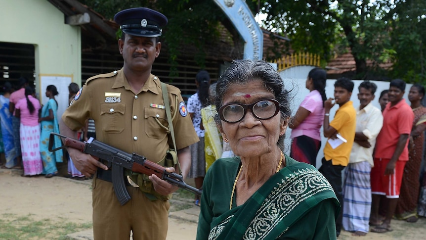 A woman leaves a polling booth after casting her vote in Sri Lanka's capital Colombo on 21 September, 2013