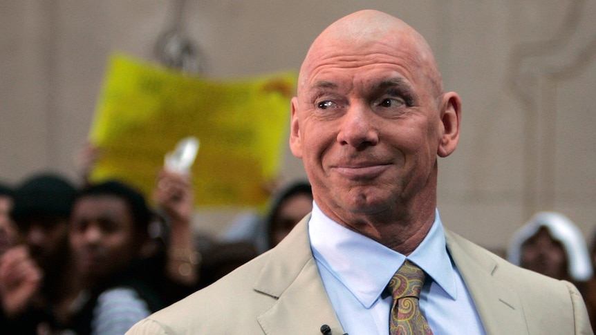 Close up of Vince McMahon wearing a suit.