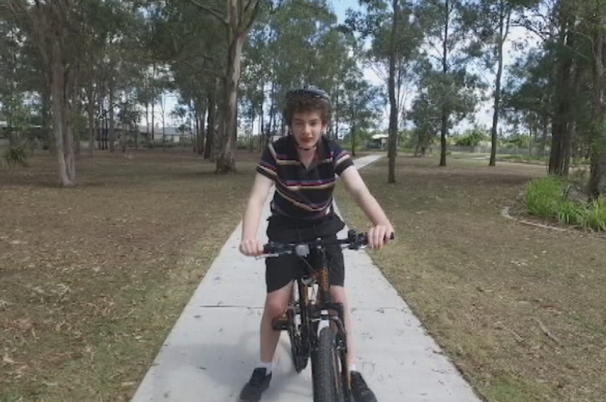 Nic hope rides his bike in a park