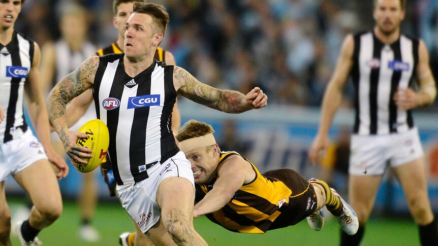 Collingwood's Dane Swan runs away from Hawthorn's Sam Mitchell during the 2012 finals series.