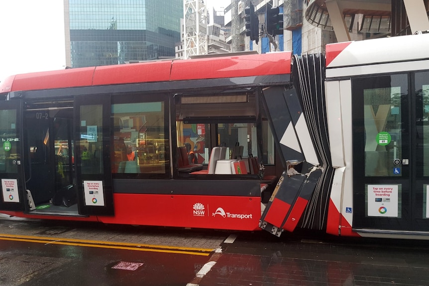 Major damage, including a large hole, can be seen on the side of a tram in Sydney.