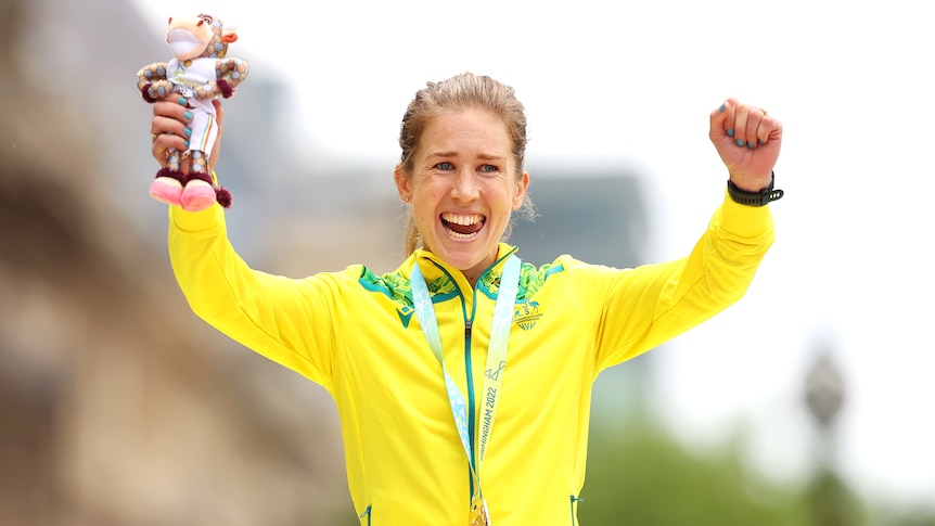 An emotional Australian marathon runner Jess Stenson smiles as she has a gold medal round her neck. 