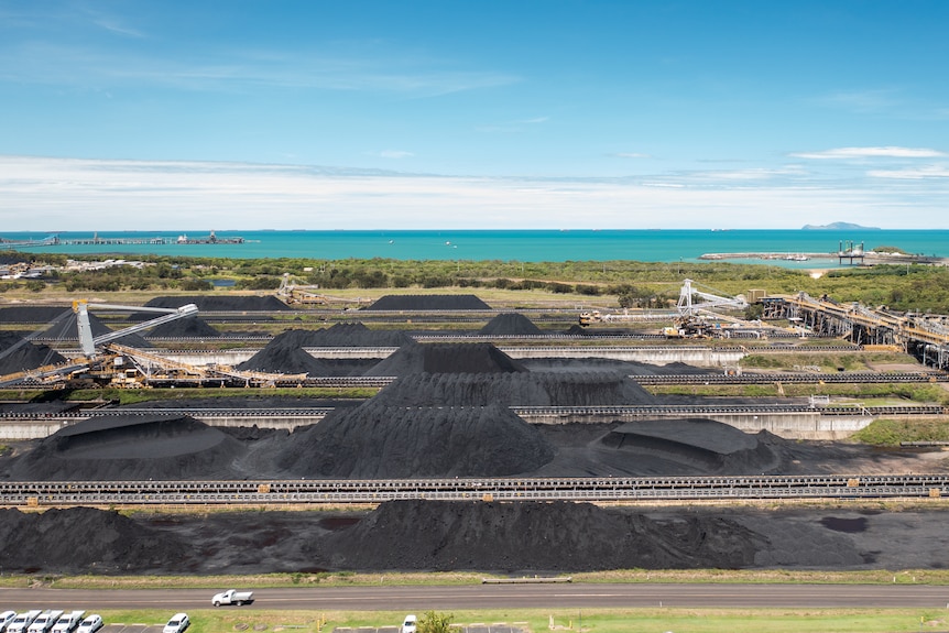 Aerial photo of huge piles of coal at Hay Point Coal Terminal, near Mackay, Queensland, November 2021.