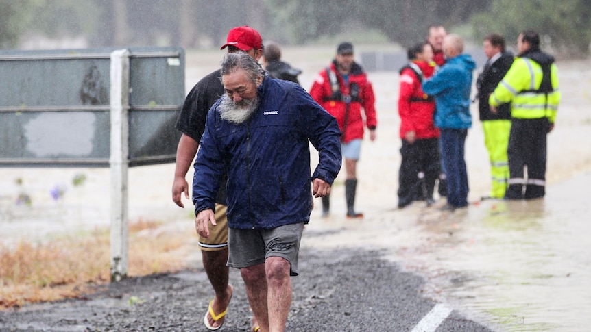 People move away from flood water in Hastings, southeast of Auckland, New Zealand.