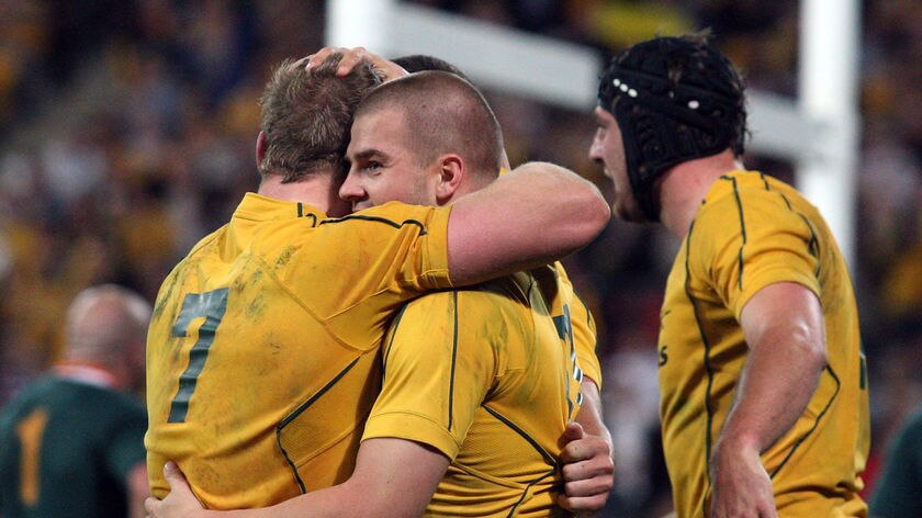 First-half try... Drew Mitchell celebrates scoring at Lang Park.