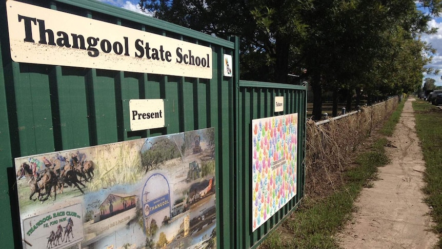 The flood high water mark is visible on the top of the school sign