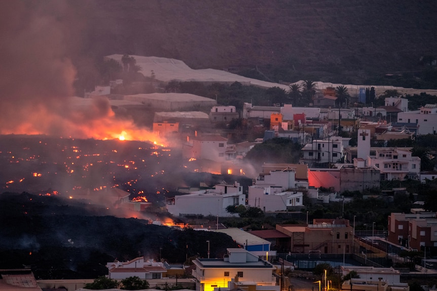 Lava flows from a volcano that destroys houses in the La Laguna district on the Canary Island of La Palma