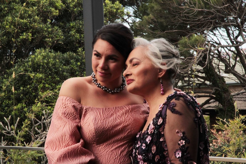 Photo of Jill Emberson wearing a floral dress on her wedding day with her daughter Malia.