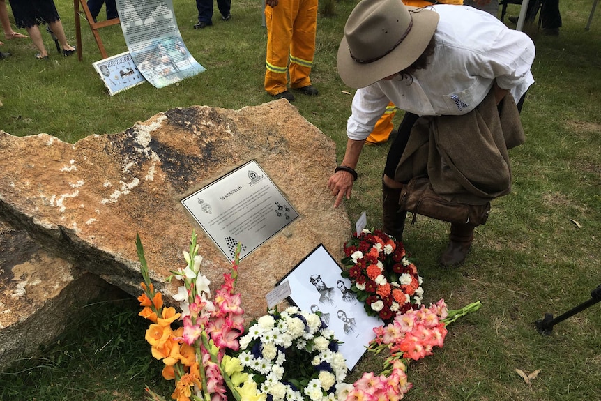 A woman lays flowers