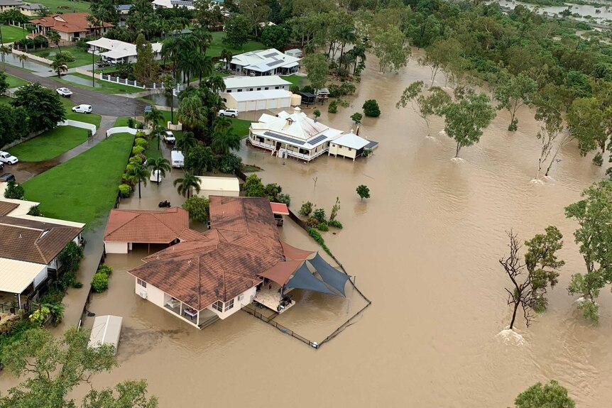 Floodwaters surrounding some homes, as seen from the air