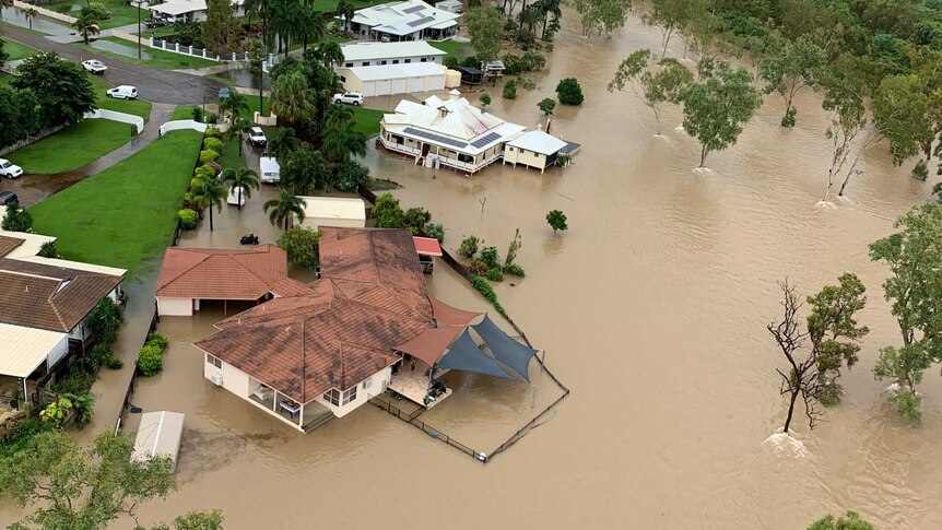 Floodwaters surrounding some homes, as seen from the air