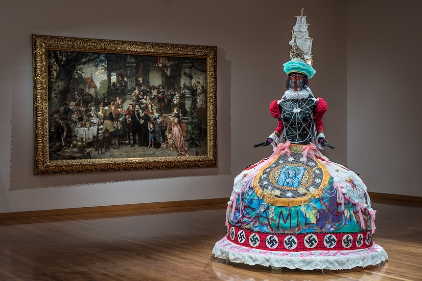 Carl Hoff's painting 'The Golden Wedding'  with a brightly coloured sculpture.