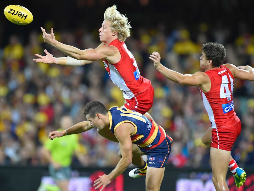 Sydney's Isaac Heeney leaps high n the back of Adelaide's Luke Brown at Adelaide Oval.