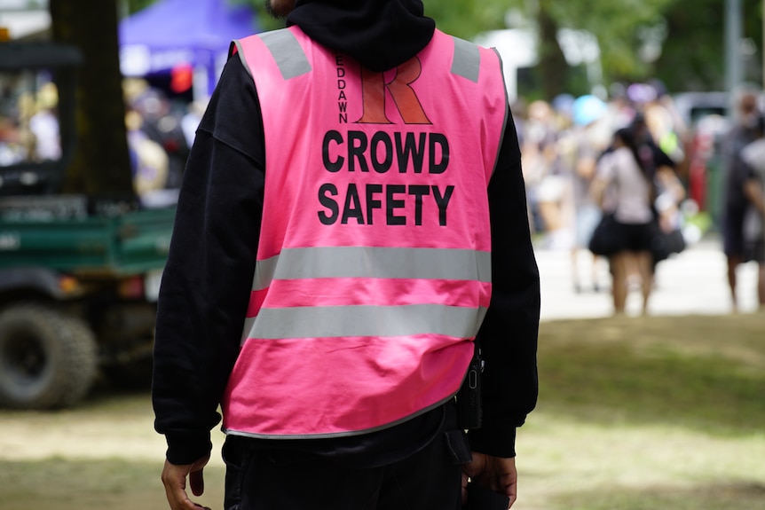 A crowd safety officer looks over the crowd at Summernats 2024 in Canberra.