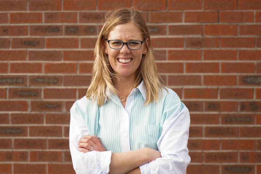 woman near brick wall 