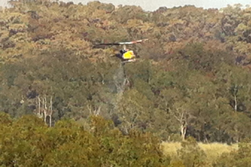 A water-bombing helicopter flies over Dudley.