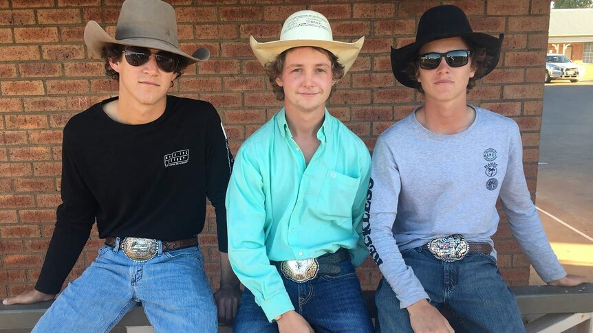 Three young men with hats and big buckles