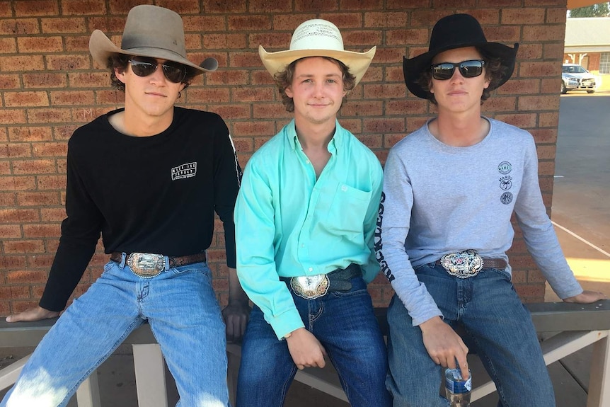 Three young men with hats and big buckles