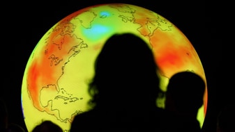 Participants watch an animated projection at the UN Climate Change Conference 2009 (Getty Images: Miguel Villagran)