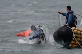 A South Korean diver enters the water near floats where the capsized passenger ship Sewol sank.