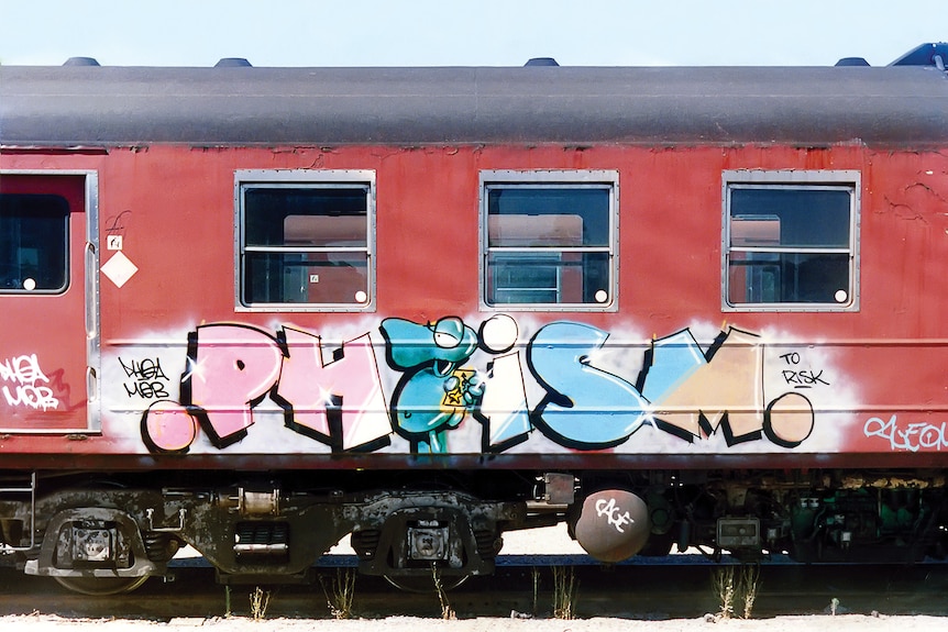 An old train with graffiti lettering on it