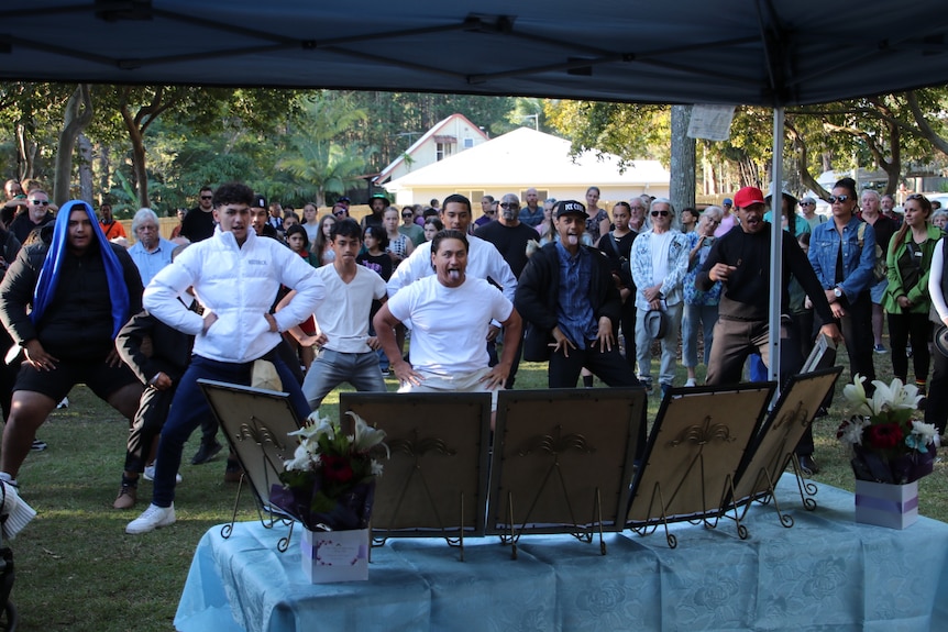 A group of men perform a haka at the Russell Island memorial