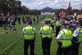Police look towards Old Parliament House as they watch over rival protesters.