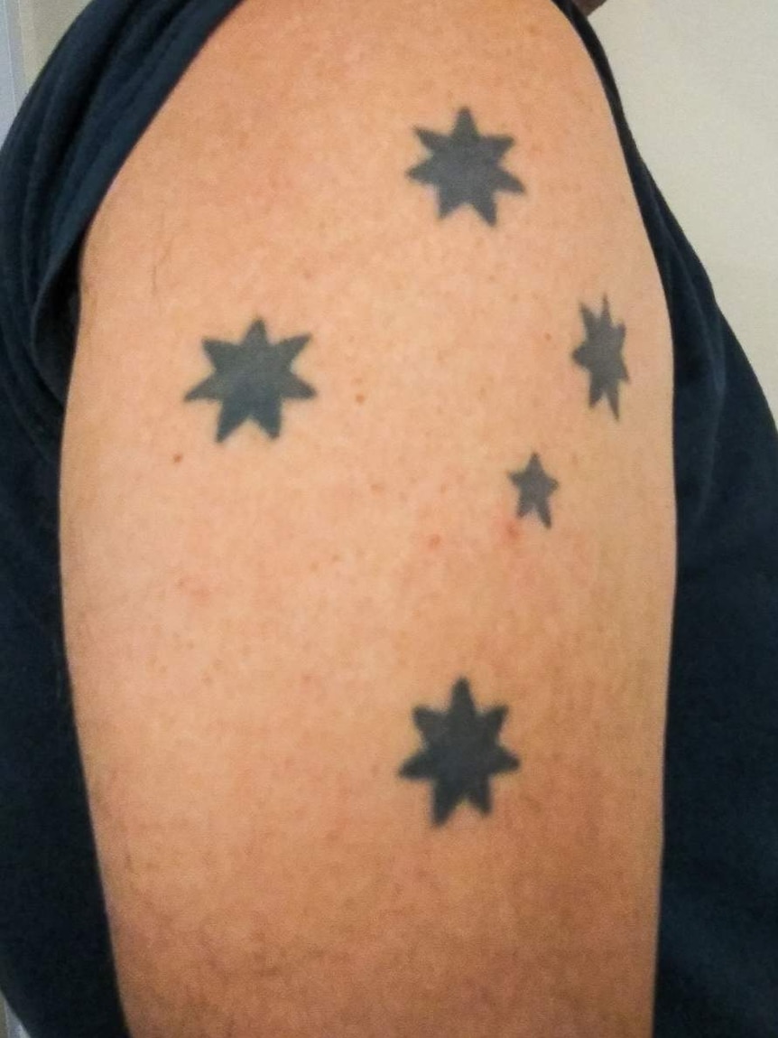 Southern Cross tattoo on shoulder.