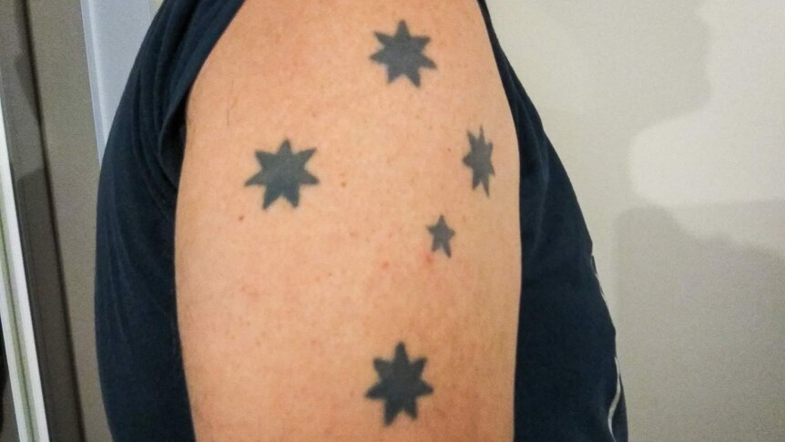 Southern Cross tattoo on shoulder.