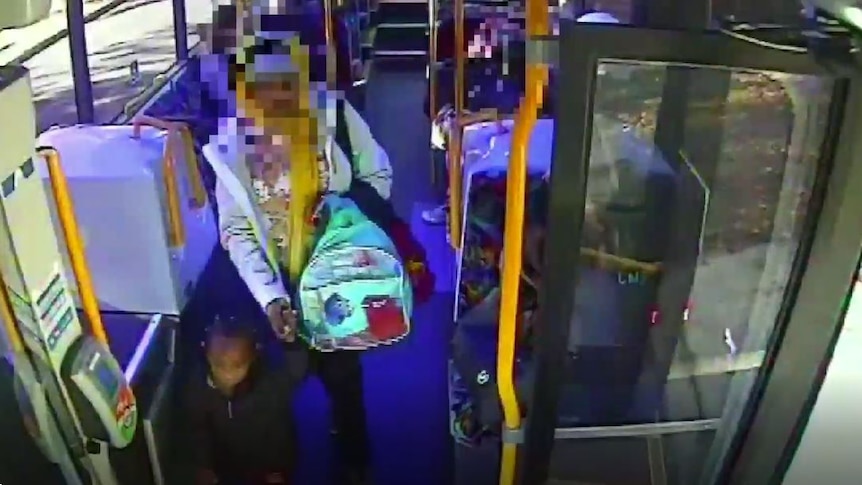 Screenshot from CCTV footage of two-year-old Safa Annour leaving bus, holding hand of deintified adult.