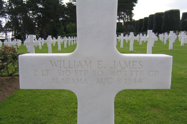 A close-up of a white cross at the grave of Second Lieutenant William E. James.