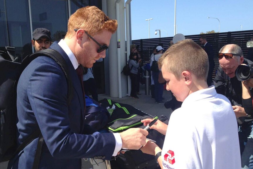 English cricketer Jonny Bairstow signs an autograph for a fan at Perth airport ahead of Ashes tour.