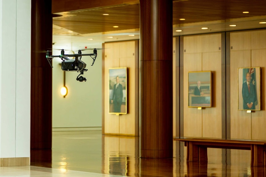 Drone flying inside Parliament House past artwork during filming of The House with Annabel Crabb.