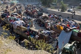 Trucks stacked with personal goods sit in a border queue as people head back to Afghanistan from Pakistan.