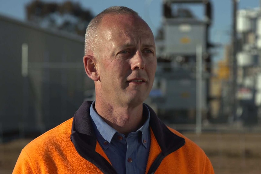 Head shot of Numurkah Solar Farm manager Paul O'Bryan standing in front a the power plant