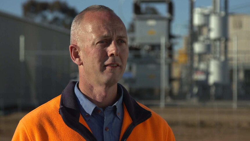 Head shot of Numurkah Solar Farm manager Paul O'Bryan standing in front a the power plant
