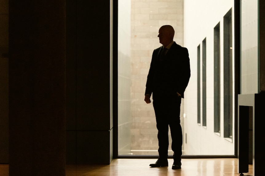 a silhouette photo of a man in a suit