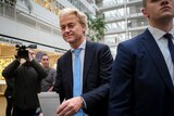 An image of Geert Wilders wearing a dark blue suit and light blue tie as he votes in the Dutch election.