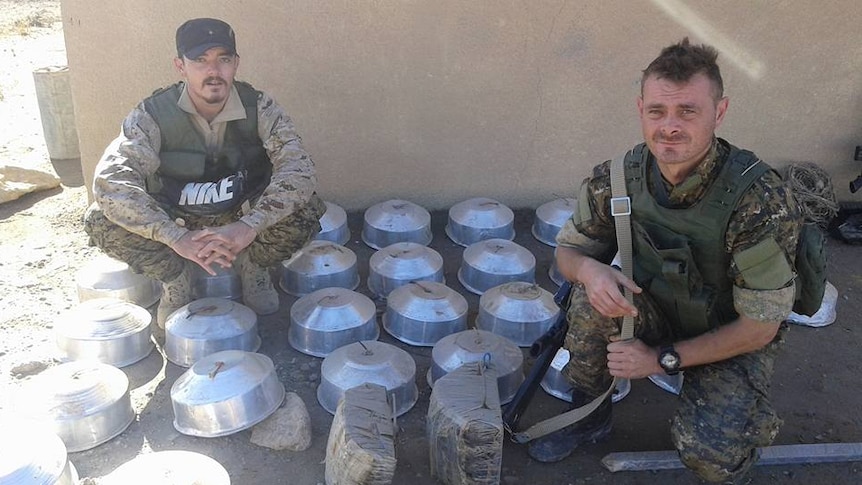 Ashley Dyball and Joe Ackerman with mines they have cleared from Kurdish villages
