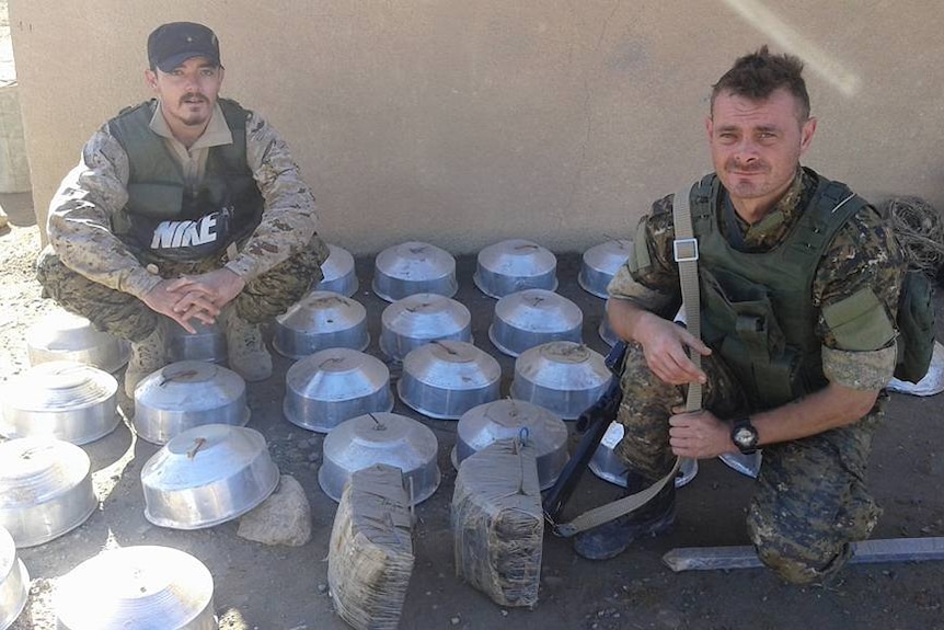 Ashley Dyball and Joe Ackerman with mines they have cleared from Kurdish villages