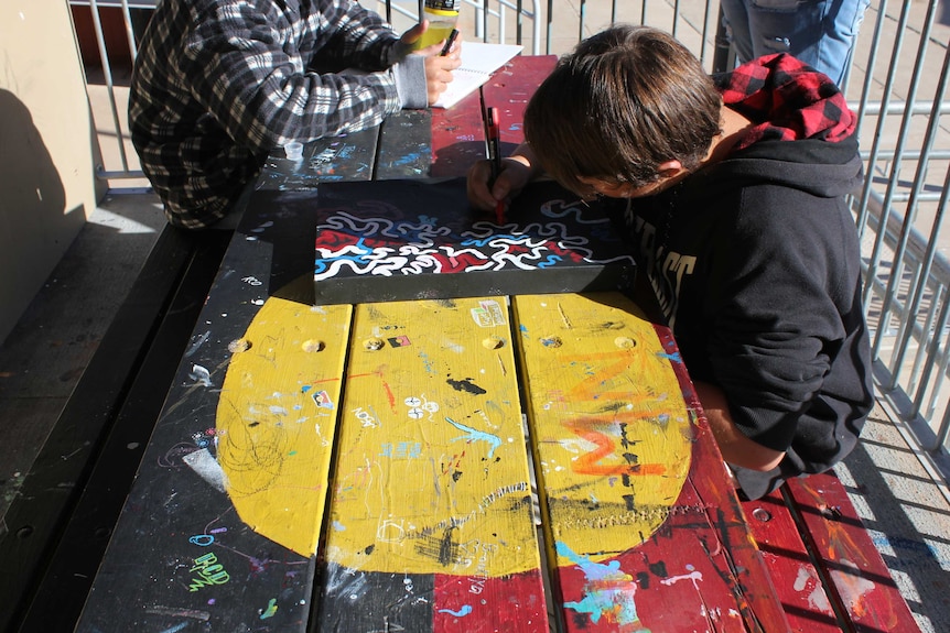 Child draws on canvas