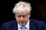 Boris Johnson looking serious and downcast while walking out of Number 10