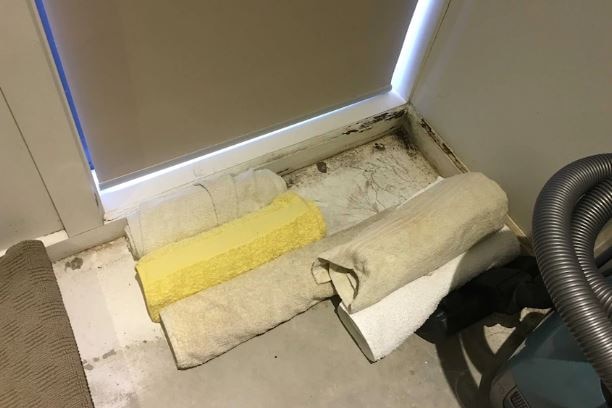 Towels soak up water on an apartment floor.