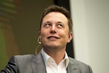 CEO of Tesla Motors Elon Musk smiles during a speech at an energy summit.